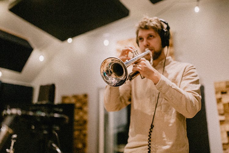 Anthony (Tony) Woloszyn from the band Good Nature laying down trumpet on their new record at Edmonton recording studio Velveteen Studios